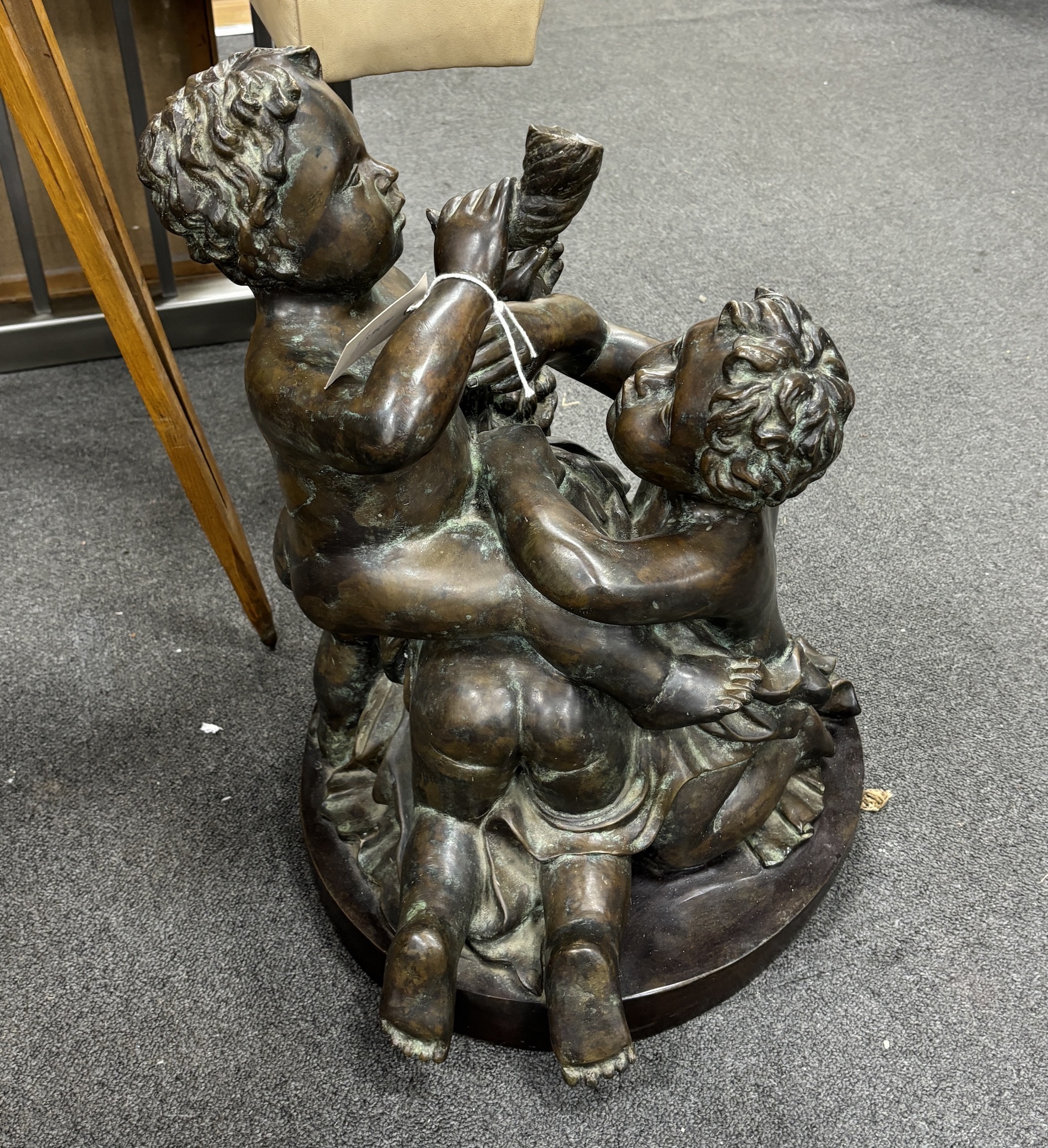 An early 20th century large bronze cherubic figure group, 52cm